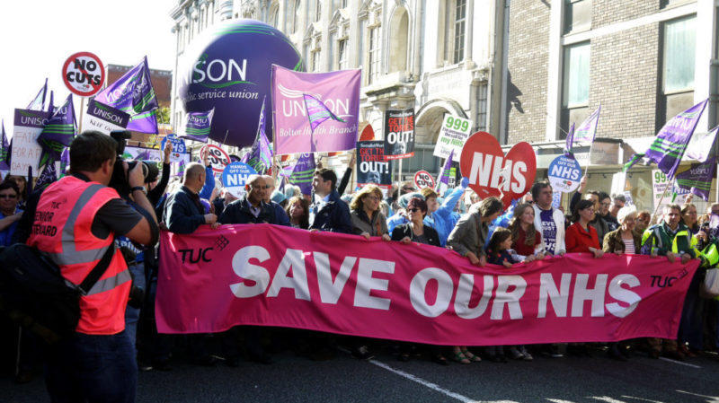 People marching in London to protest NHS cuts.